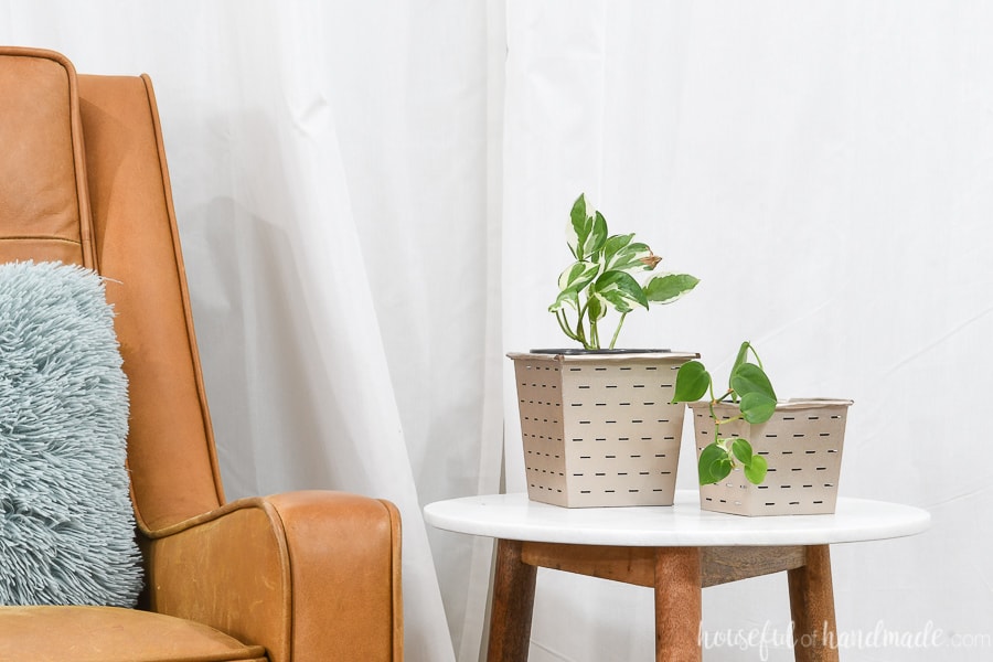 Leather chair next to table with paper flower pots covering budget potting containers. 