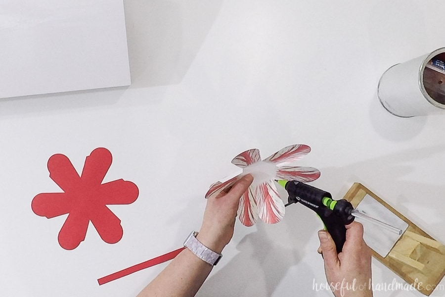 Glueing together the paper Easter Basket with a hot glue gun.