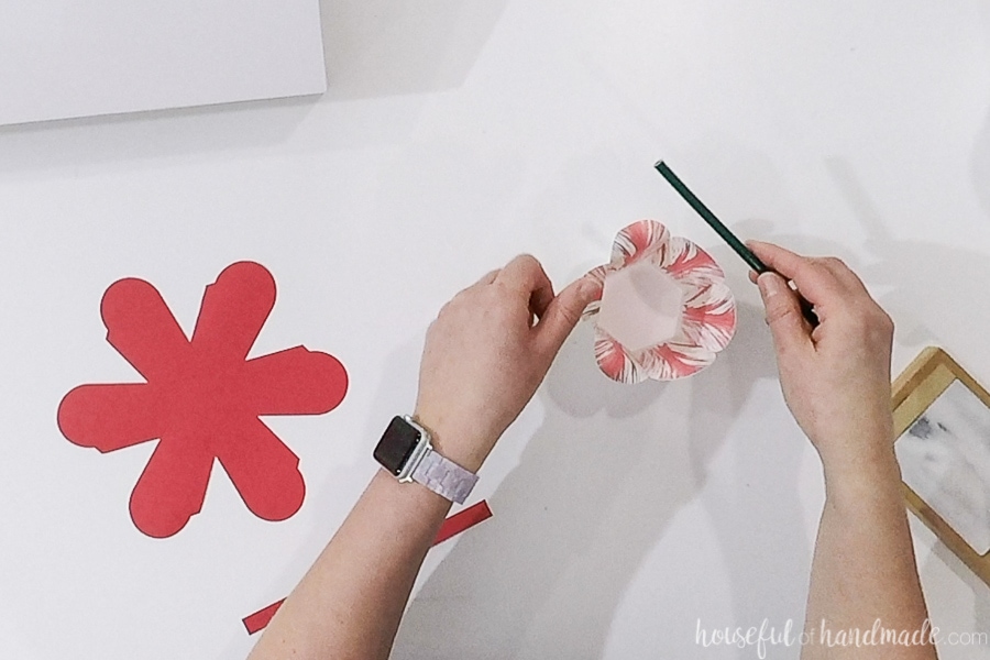 Curling the top of the flower petals over a pencil.
