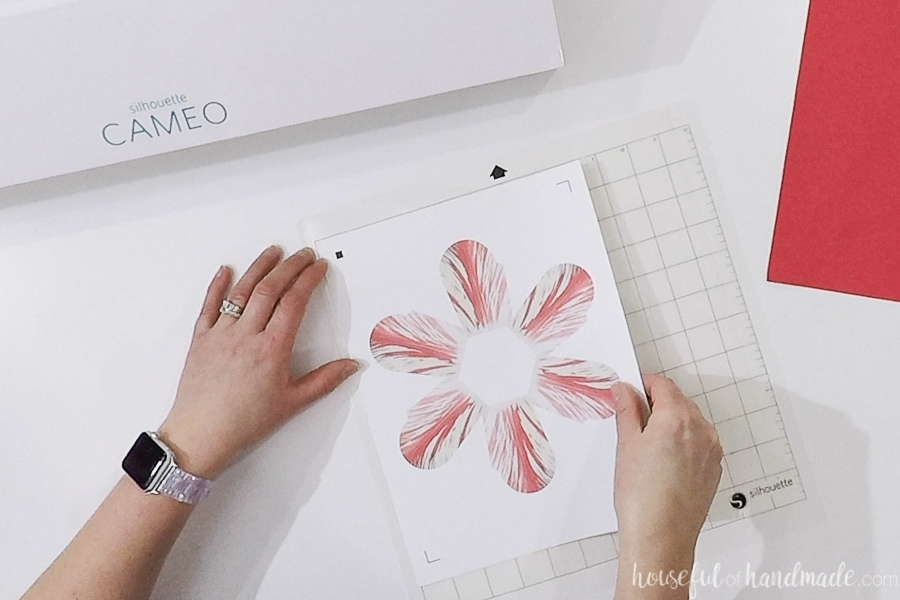 Cutting out the flower basket SVG with the Silhouette Cameo cutting mat.