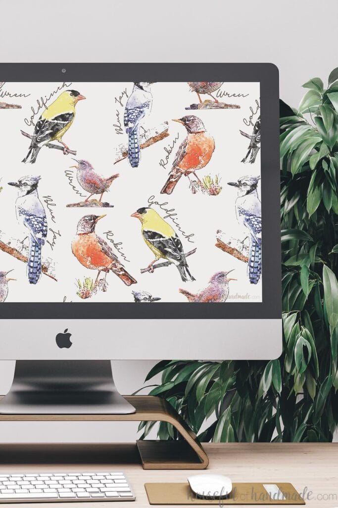 Desktop computer with the free digital wallpaper for March on the background.