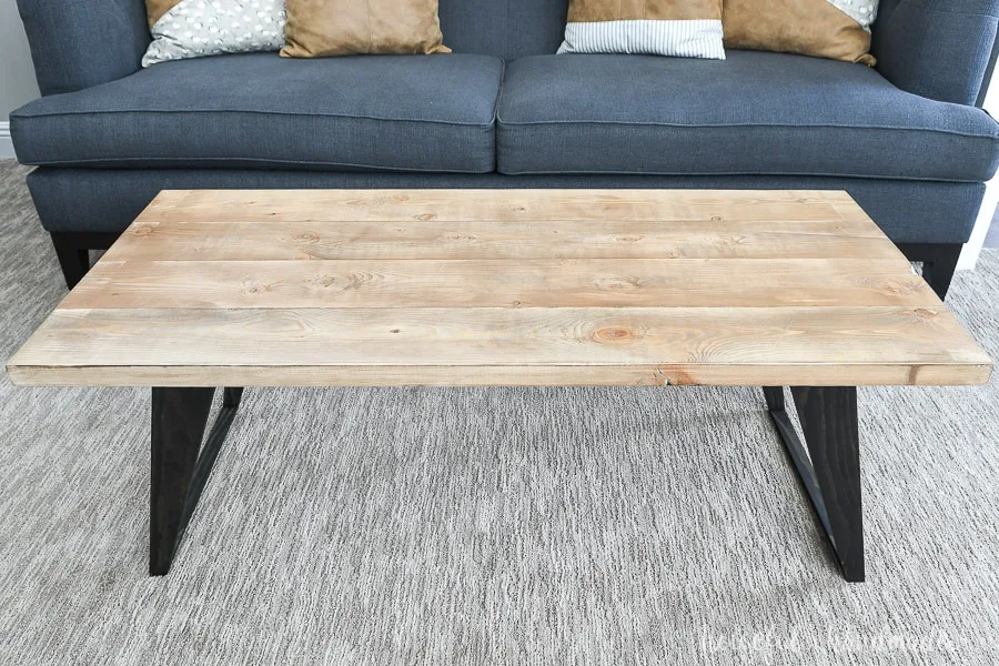 Looking down at the top of the coffee table with a warm natural wood finish on it. 