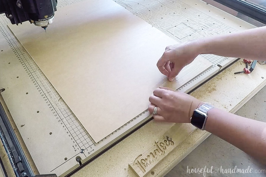 Adding tape to the back of the acrylic sheet to secure to the waste board. 