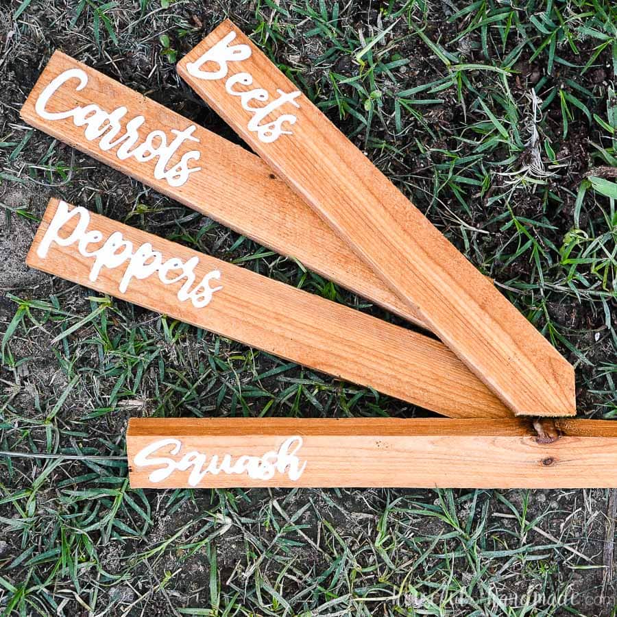 Beets, Carrots, Peppers, and Squash garden markers made from cedar fence pickets on the ground.