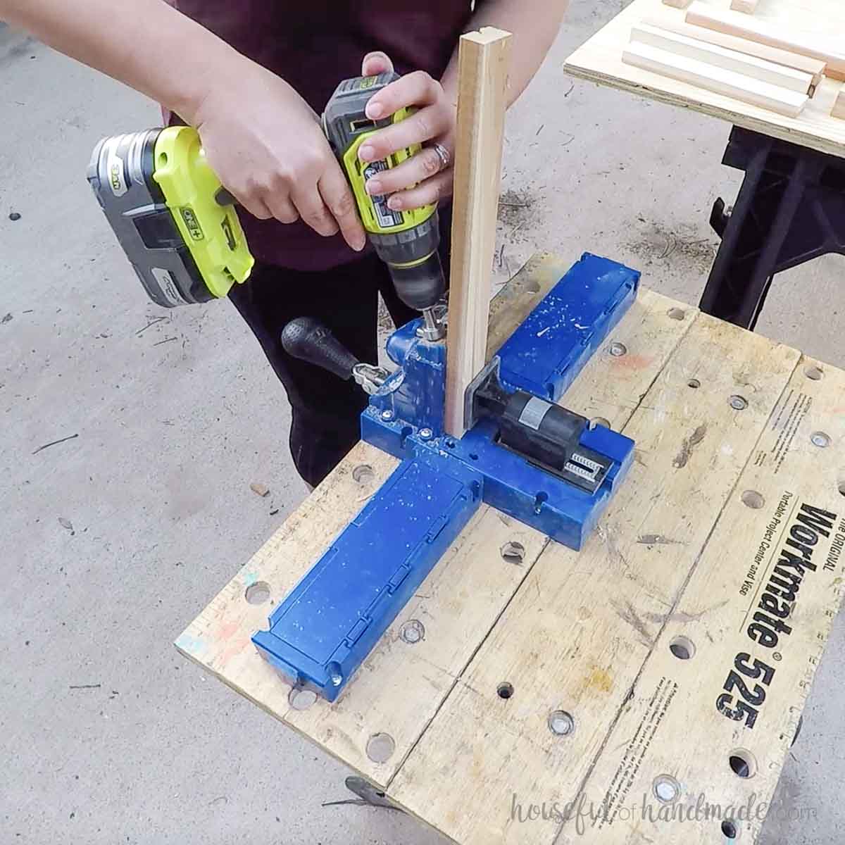 Drilling pocket holes in a board. 