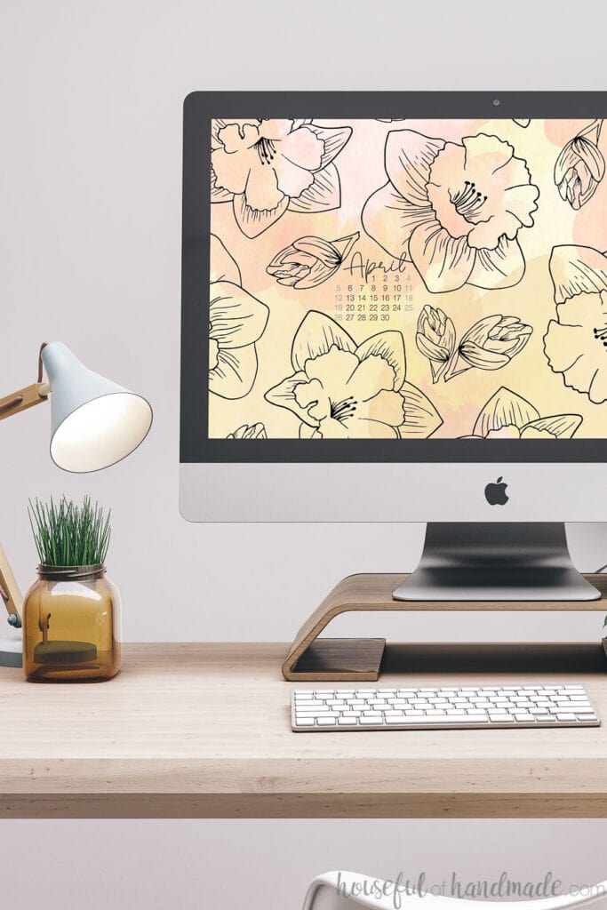 iMac computer with spring digital wallpaper of daffodil print on the background.