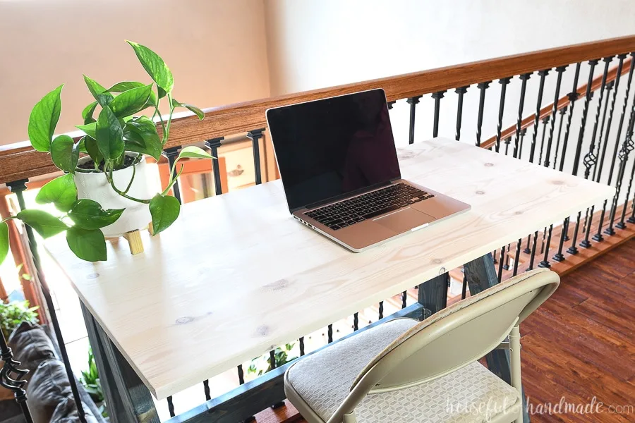 Desk top made from 1x6 boards for the folding desk stained with white wood stain. 