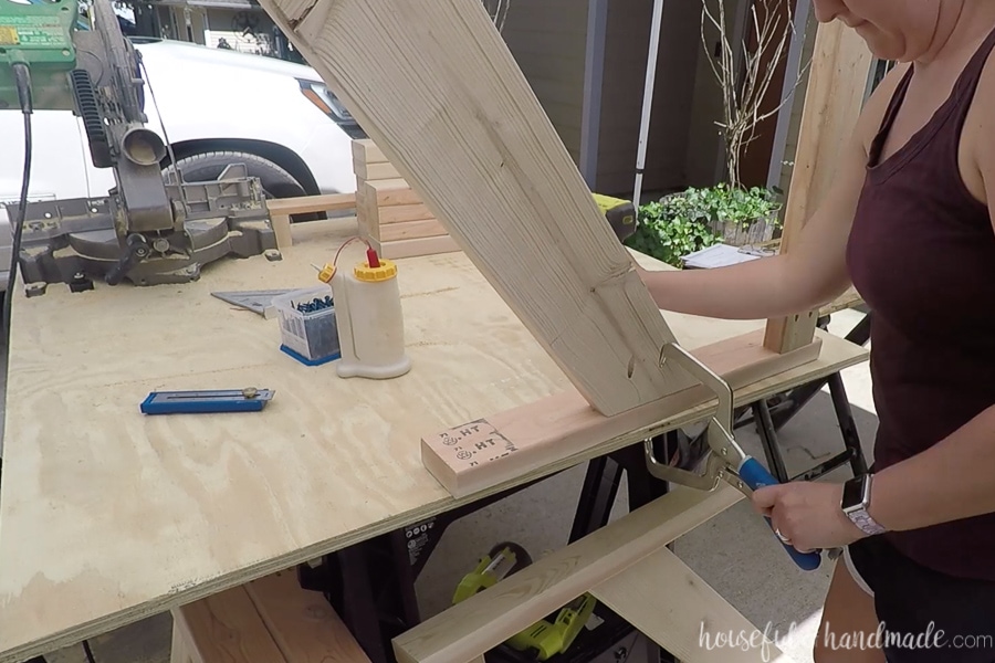 Attaching the legs to the armrest of the chair for the side pieces. 