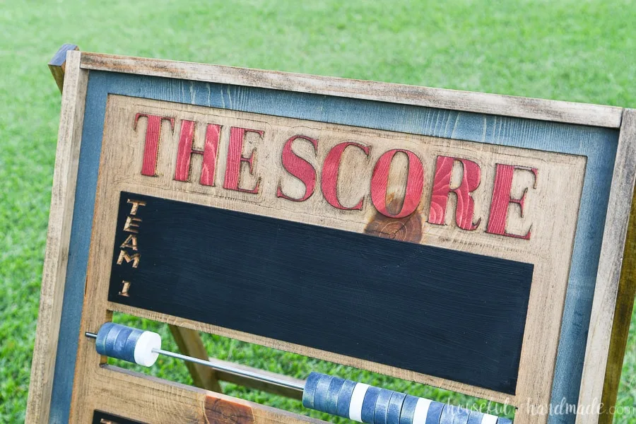 Close up shot of the carved words "The Score" on the top of the score keeper board. 