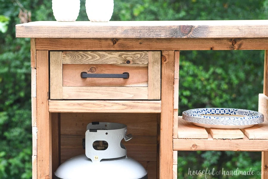 Close up view of the front of the drawer in the grill side table. 