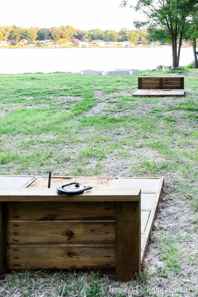 A permanent horseshoe pit set up on the lawn overlooking the lake. 
