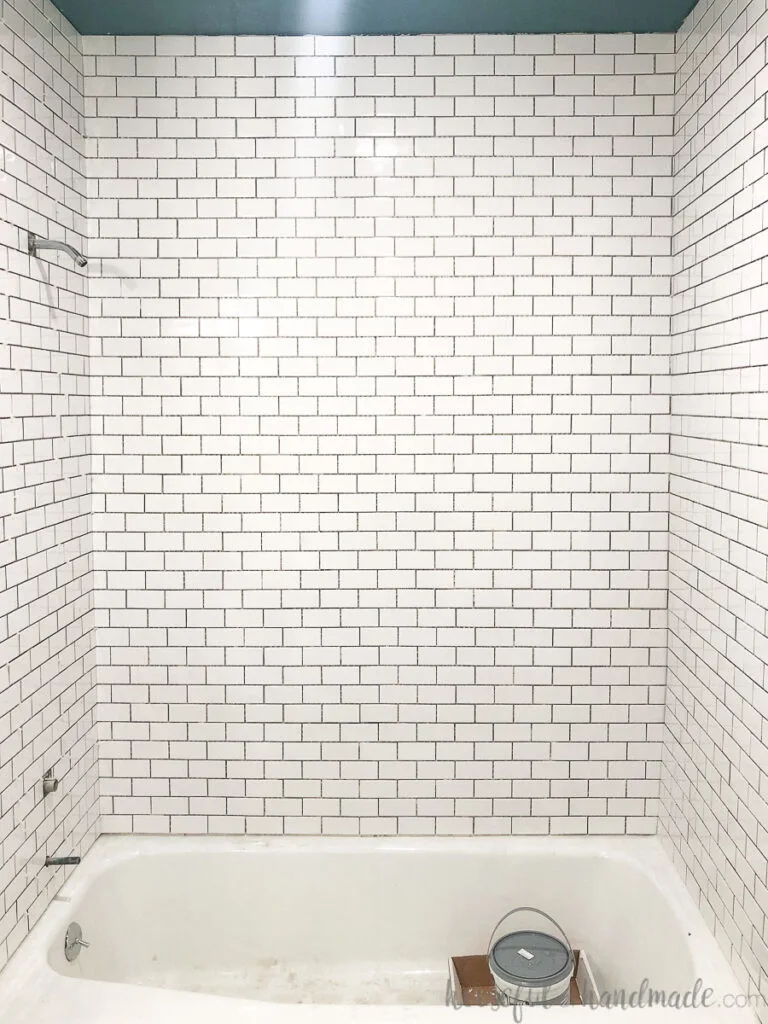 Tub surround tiled with 2x4 subways tiles on a 12x12 sheet.