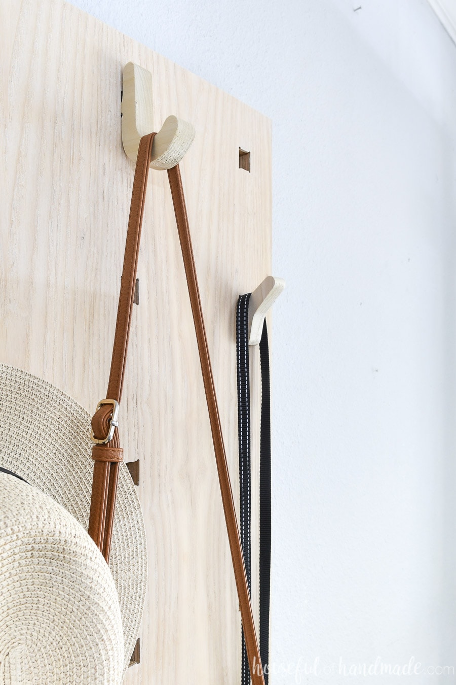 Close up picture of the two styles of hooks on the pegboard style entry organizer. 