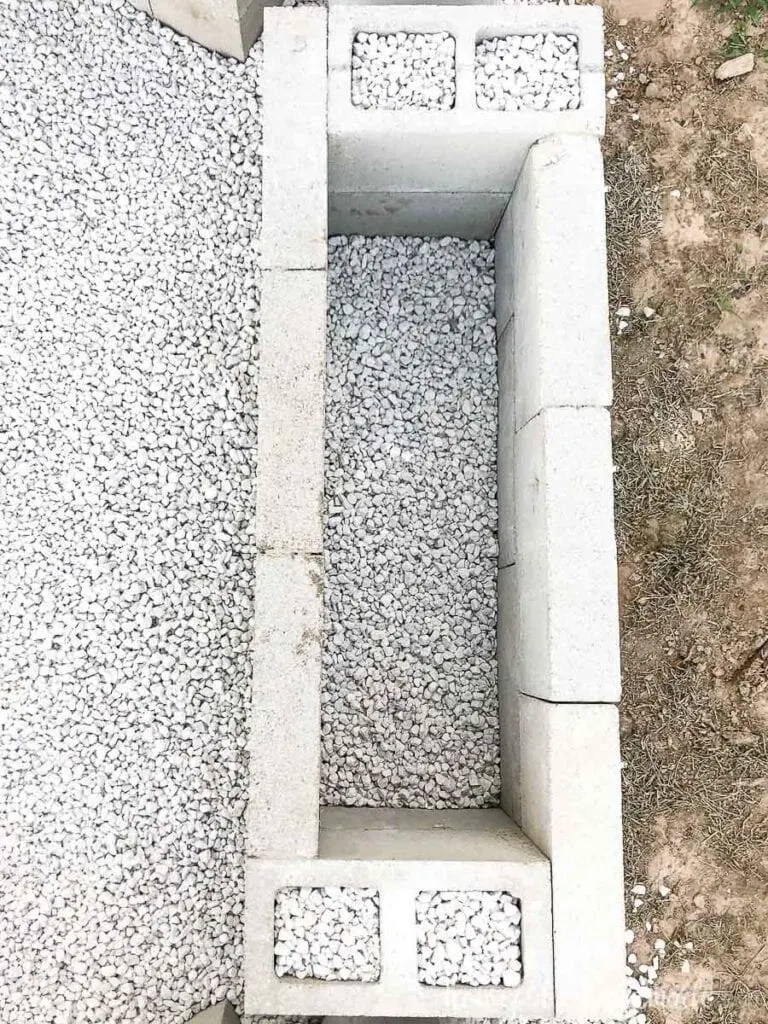 Top down view of the fire pit seating bases made from cinderblocks and filled with crushed limestone rock. 
