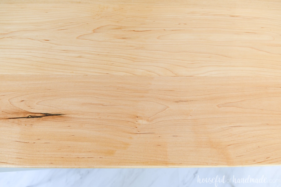 Top down view of the sealed maple wood countertops showing the marble vinyl floor below. 