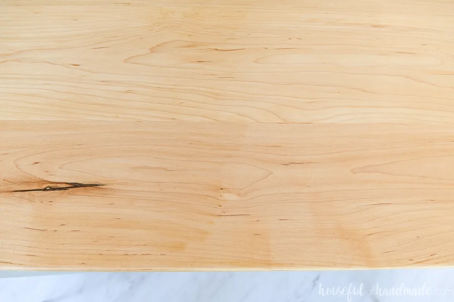 Top down view of the sealed maple wood countertops showing the marble vinyl floor below. 