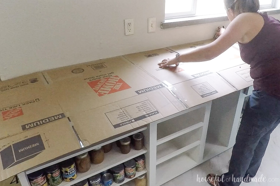 Using cardboard to create a template for DIY countertops.