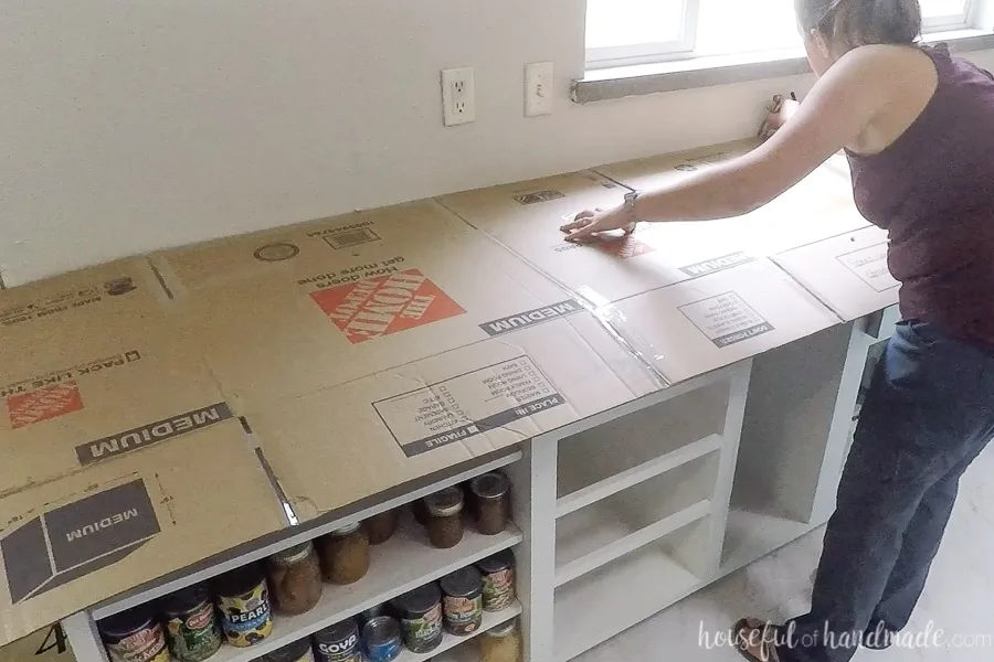 Using cardboard to create a template for DIY countertops.