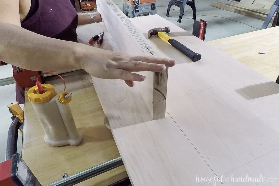 Adding glue to edge of one of the boards for the countertop.