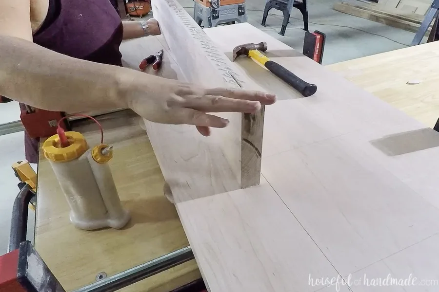 Adding glue to edge of one of the boards for the countertop.