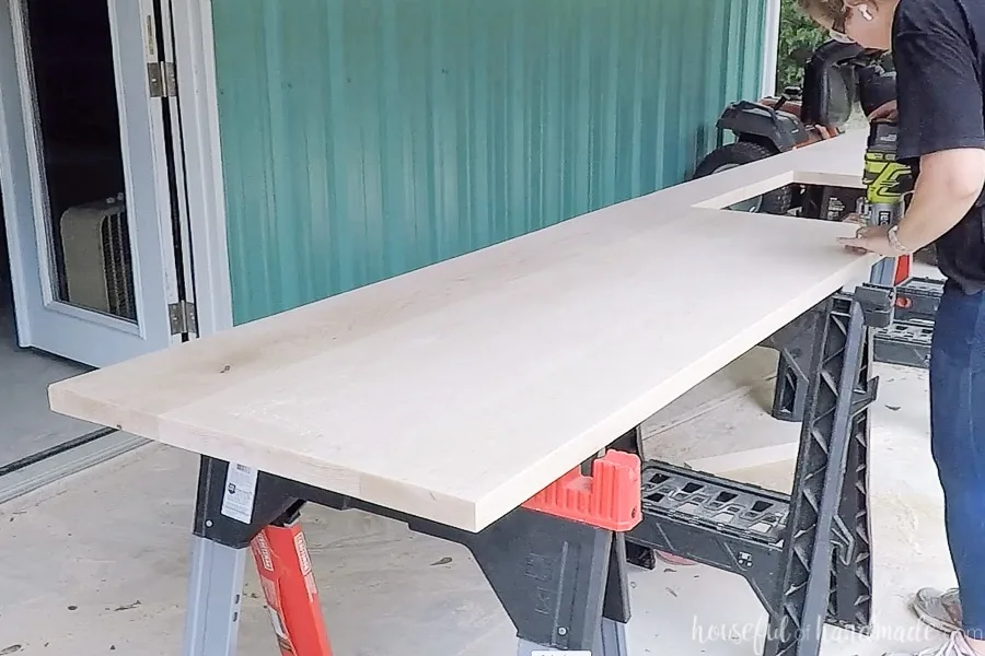 Using a palm router to add a roundover to the top edges of the countertops. 