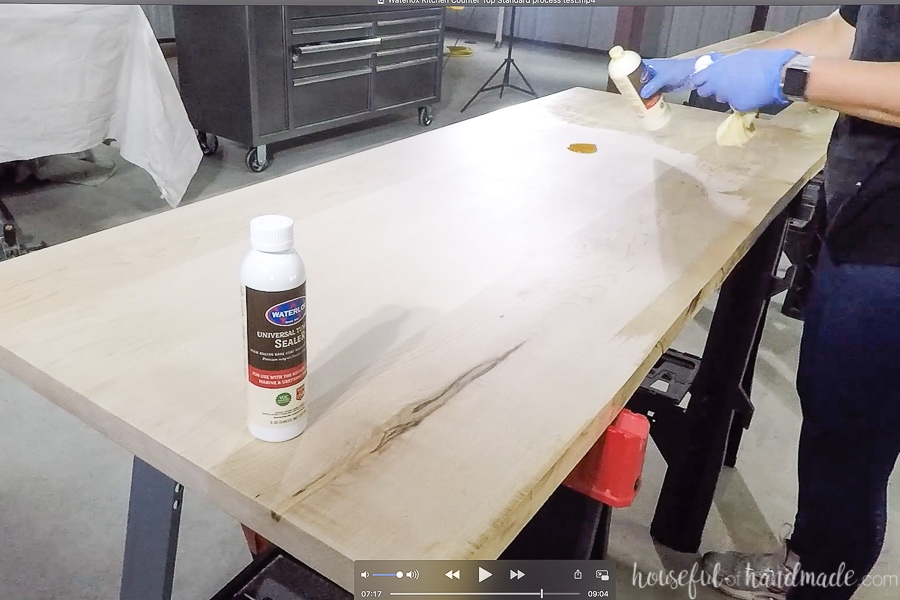 Applying the Universal Tung Oil sealer to the finished countertops by pouring a small puddle of sealer on the wood. 