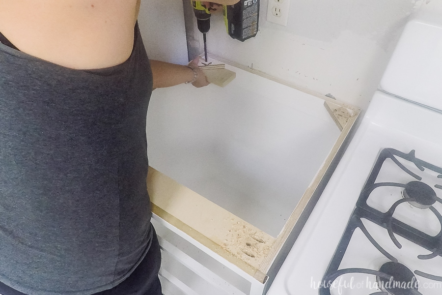 Drilling 3/8" holes in the countertop supports to attach the countertops with room for wood movement. 