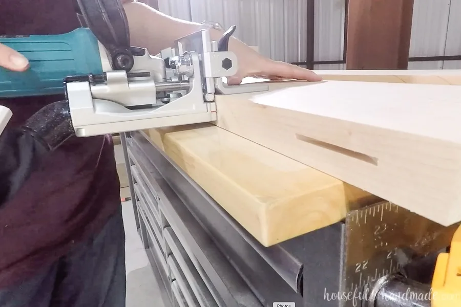 Cutting biscuit slots into the edges of the countertop boards.