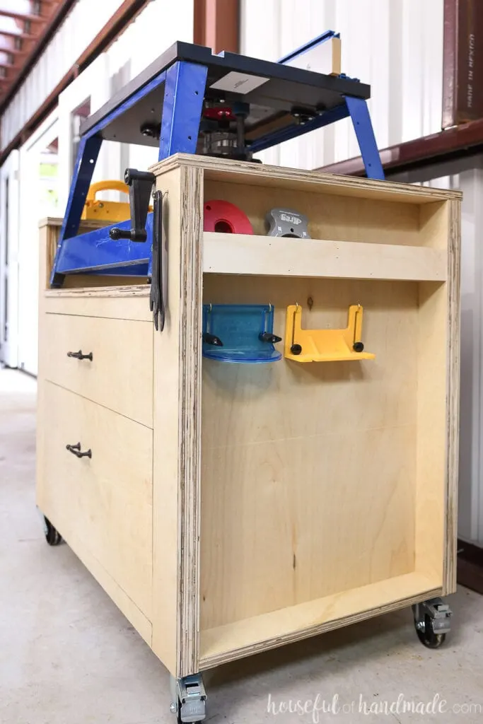 The right side of the router table made from plywood with cubbies and hooks for router accessories. 