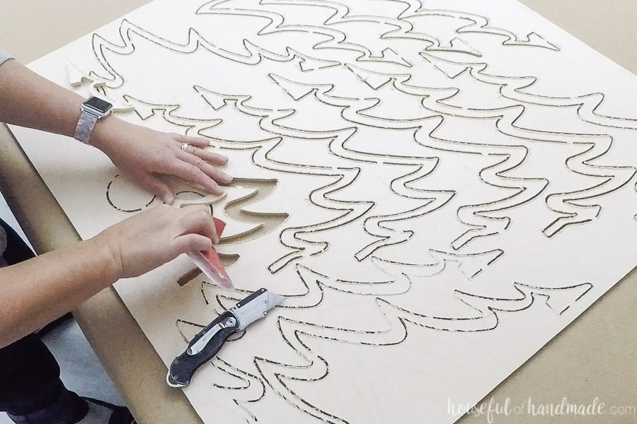 Sanding the edges of the cut plywood. 