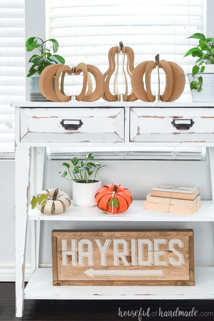 Fall vignette with 3D paper pumpkins and wood Hayrides sign.