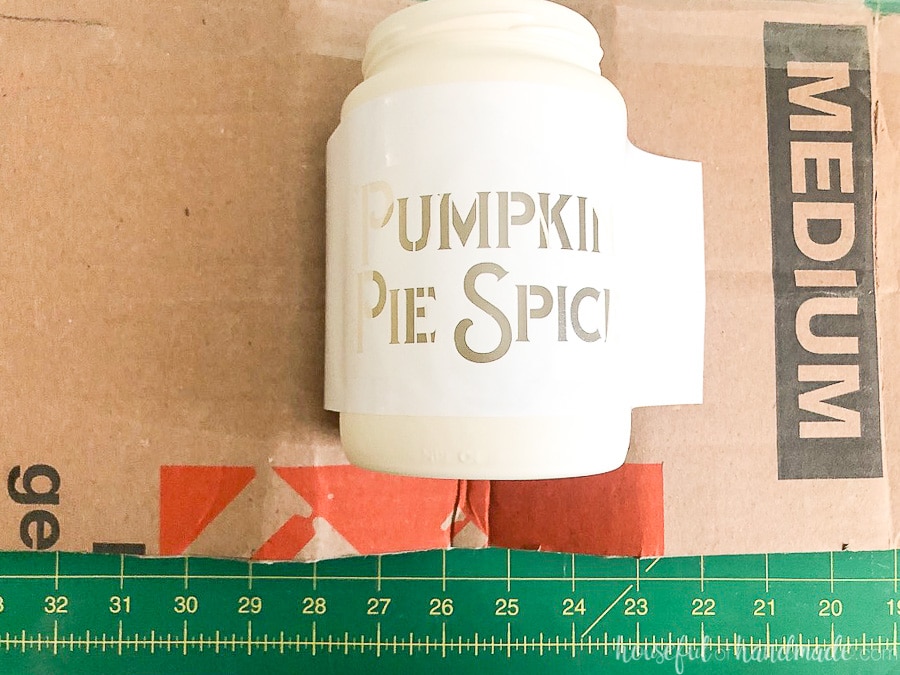 Cream sprayed jar with Pumpkin Pie Spice stencil added to the top of it. 