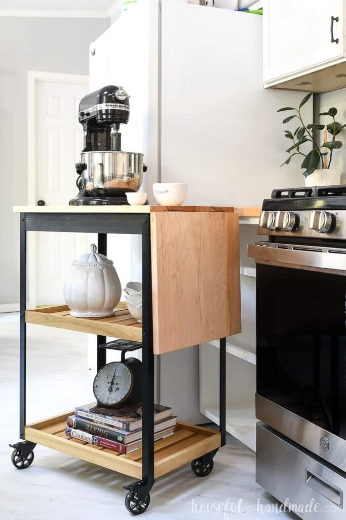 Side view of the rolling kitchen cart with the leaf dropped down.