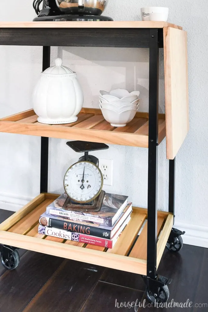 Close up of the two natural wood shelves on the modern kitchen cart.