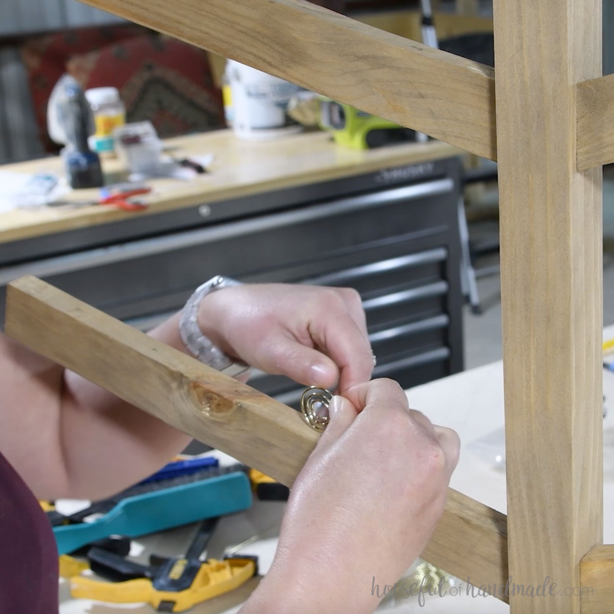 Inserting photo holders in the limbs of the tree. 