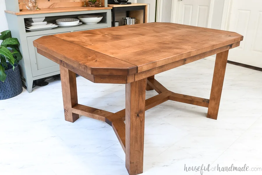 Dining table with breadboard ends that open to hold leaves and sealed with matte unfinished look sealer. 