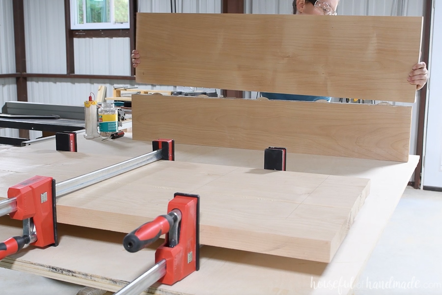 Glueing up the second side of the table top in the background while the first is clamped in the foreground.