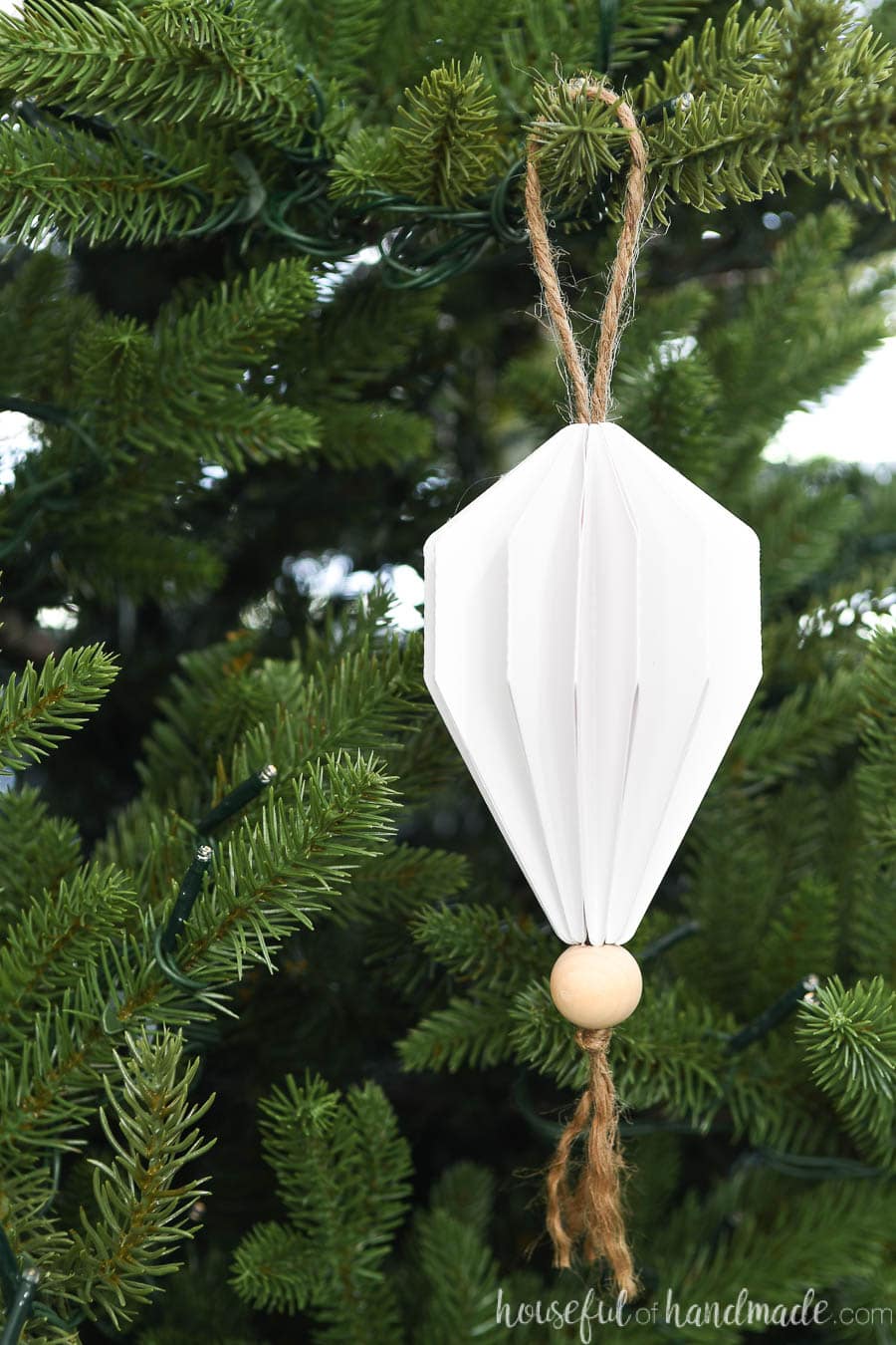 Close up of the 3D paper Christmas ornament with an origami jewel design.