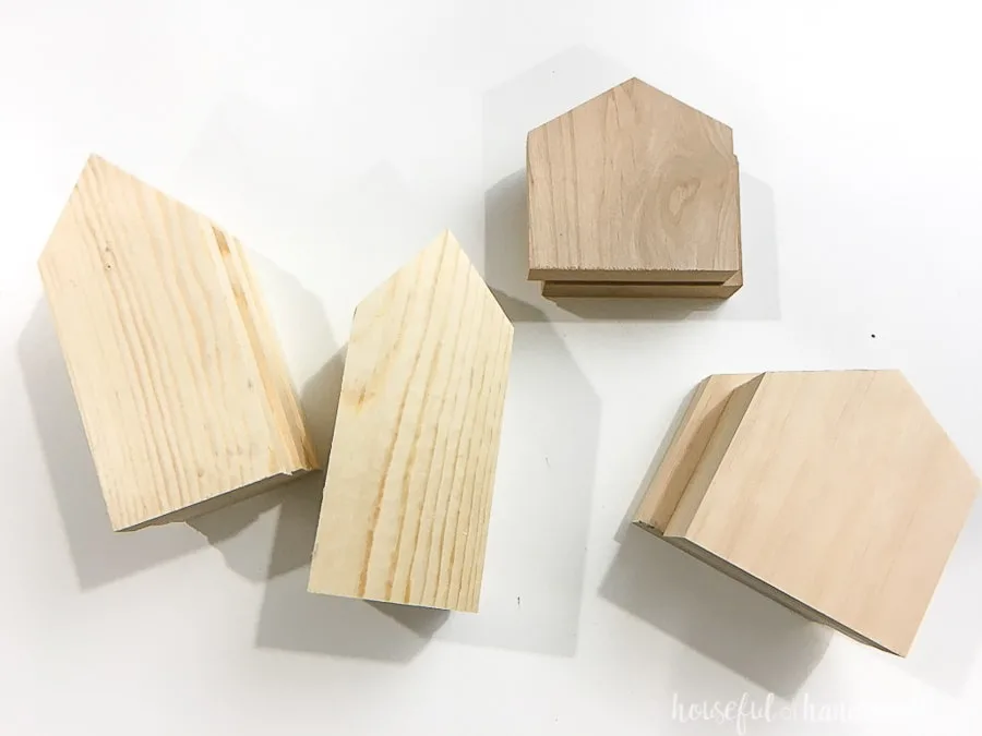 Eight house shaped pieces of wood.