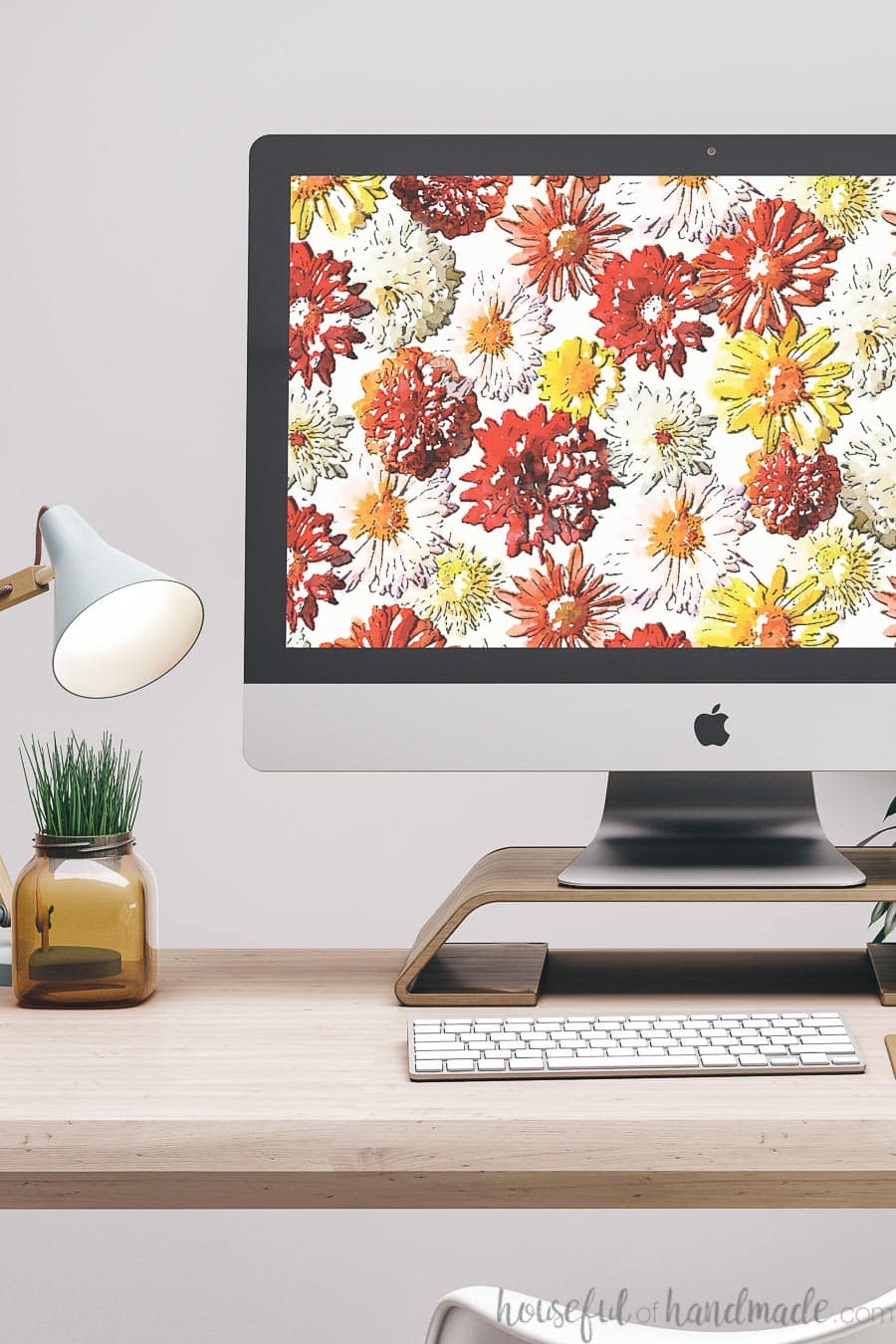 iMac desktop computer with watercolor fall mum print on the screen as digital wallpaper.