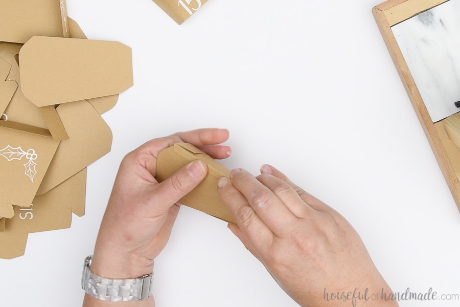 Glueing the side flaps to the back to finish the pocket.
