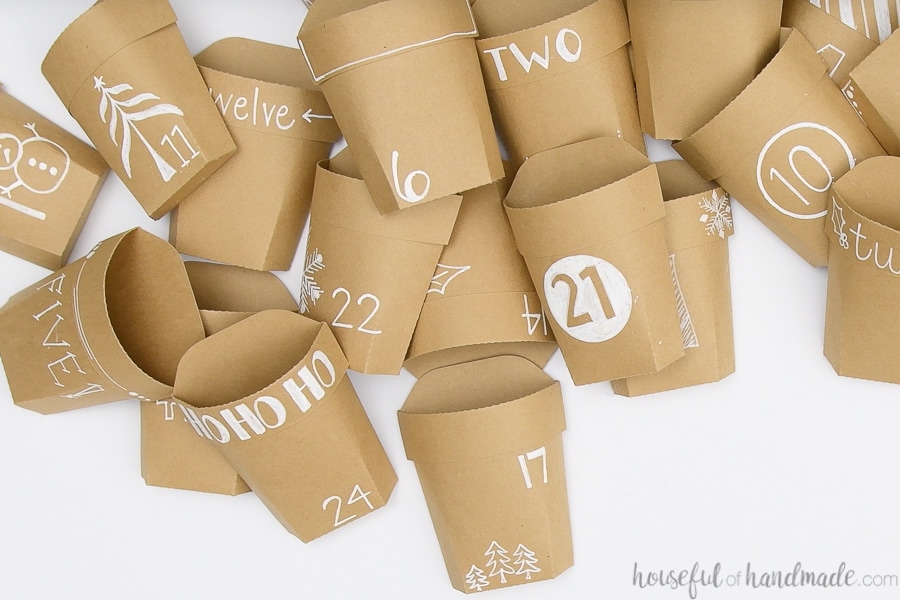 Pile of 24 assembled and decorated paper pockets for the reusable advent calendar.