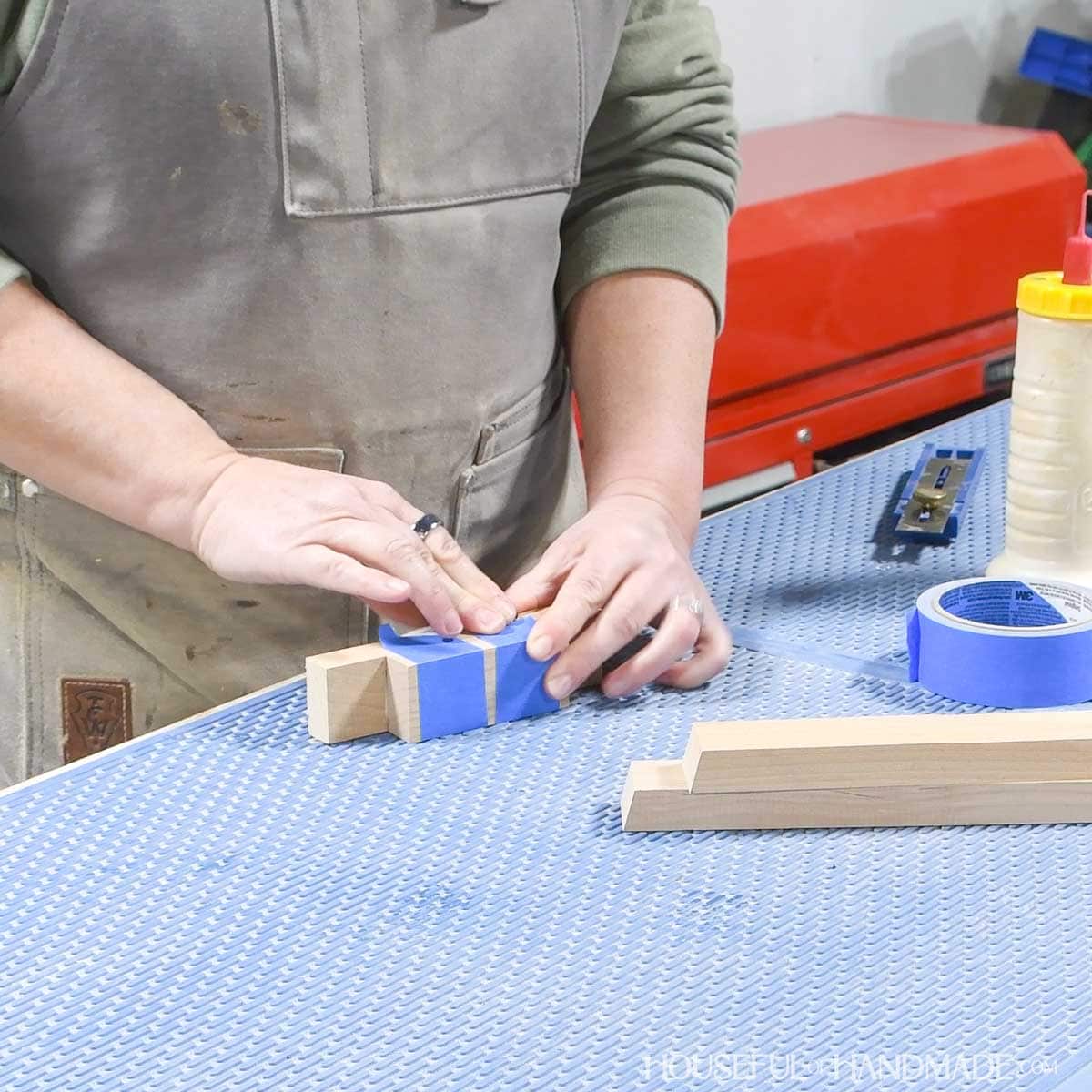 Glueing the trunk to the base and securing with tape.