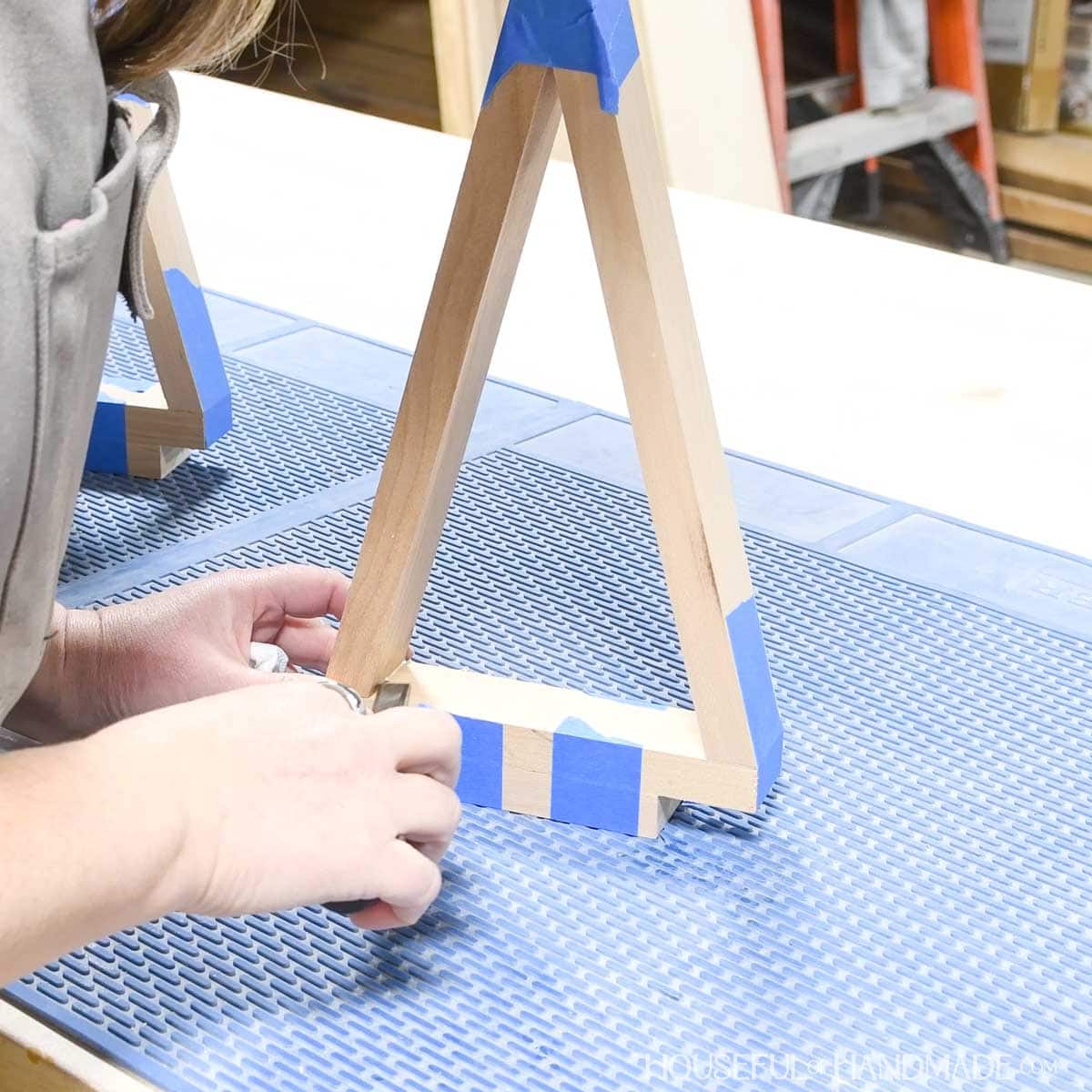 Scraping glue squeeze out with a chisel.