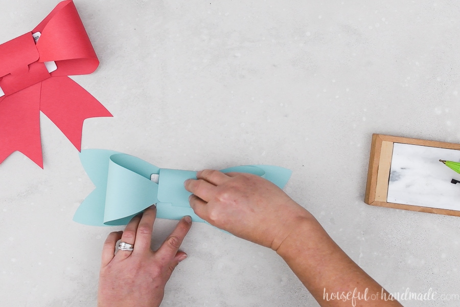 Folding the second gift card bow around a Starbucks gift card.