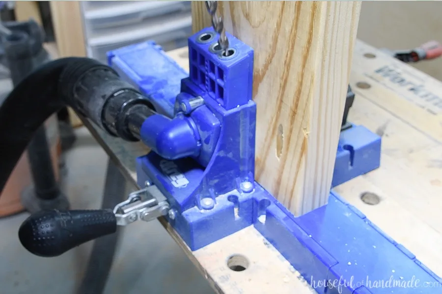 Close up of drilling pocket holes in the 2x8 boards with the Kreg K5 pocket hole system.