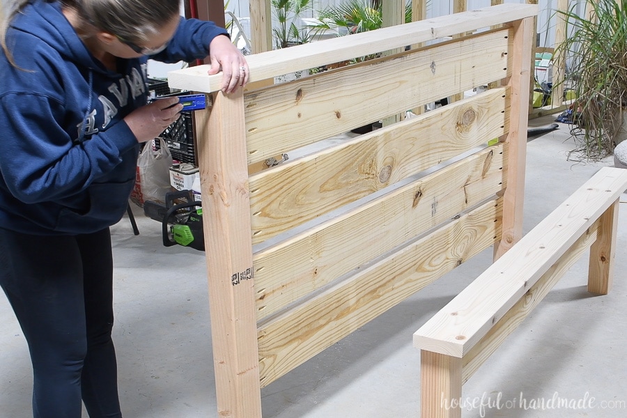 Lining up the top of the headboard before attaching it. 
