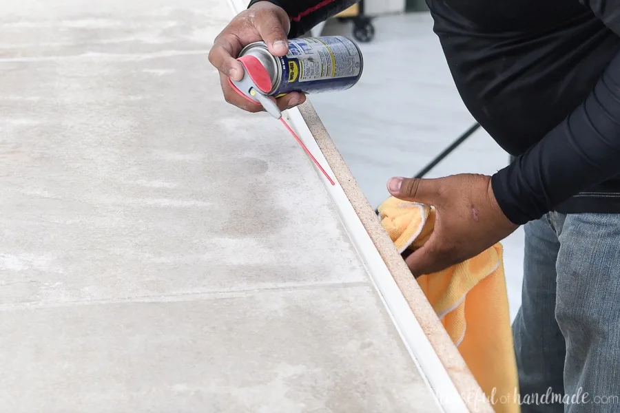 Adding WD40 to the inside of the concrete countertop form and wiping away the excess with a clean rag.