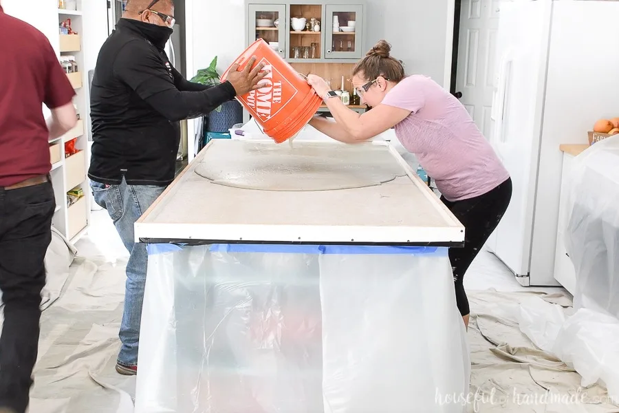 Pouring the second bucket of mixed Cement All with the additives into the kitchen island form. 