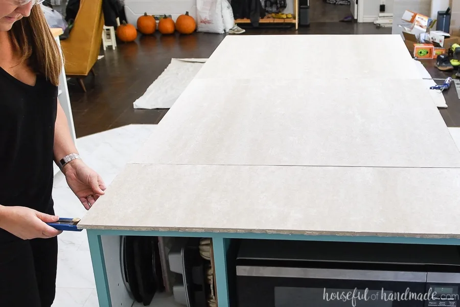 Measuring the overhang of the cement board for the concrete countertop forms. 